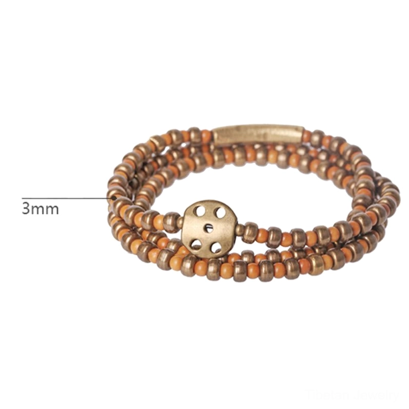 Close-up front view of 3mm olive pit copper beads with size scale reference, highlighting individual bead detail on neutral background