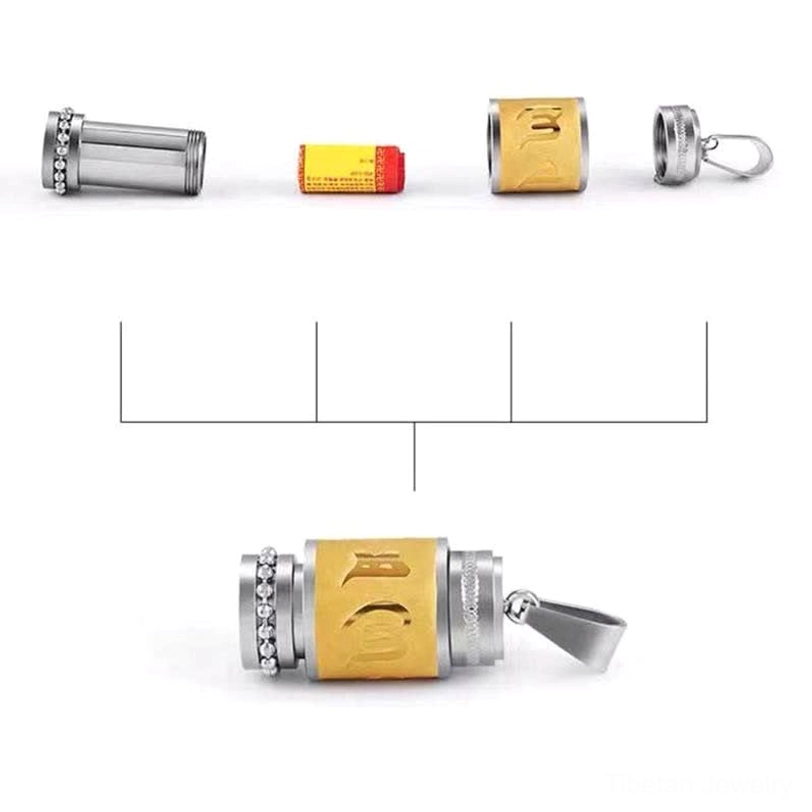 Disassembled Tibetan prayer wheel amulet showing pendant shell, mantra tube, decorative components and assembly structure