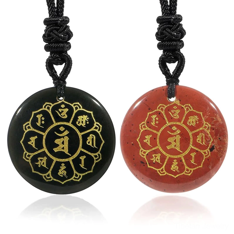 Two Tibetan mantra pendants - black obsidian and red stone with matching golden Sanskrit design