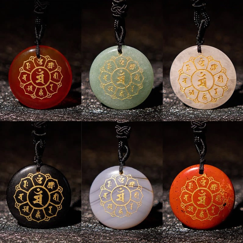 Six crystal variety Om Mani Padme Hum pendants - black obsidian, white crystal, green aventurine, red agate displayed together