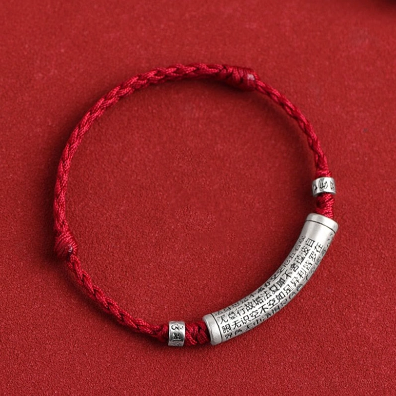 Tibetan Om Mani Padme Hum bracelet with red braided rope flat lay showing complete product design and engraved details