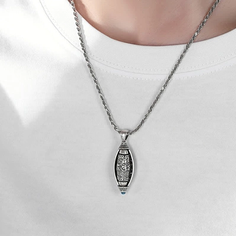 Om Mani Padme Hum necklace worn on model in white shirt showing slim silver chain and compact pendant for daily wear