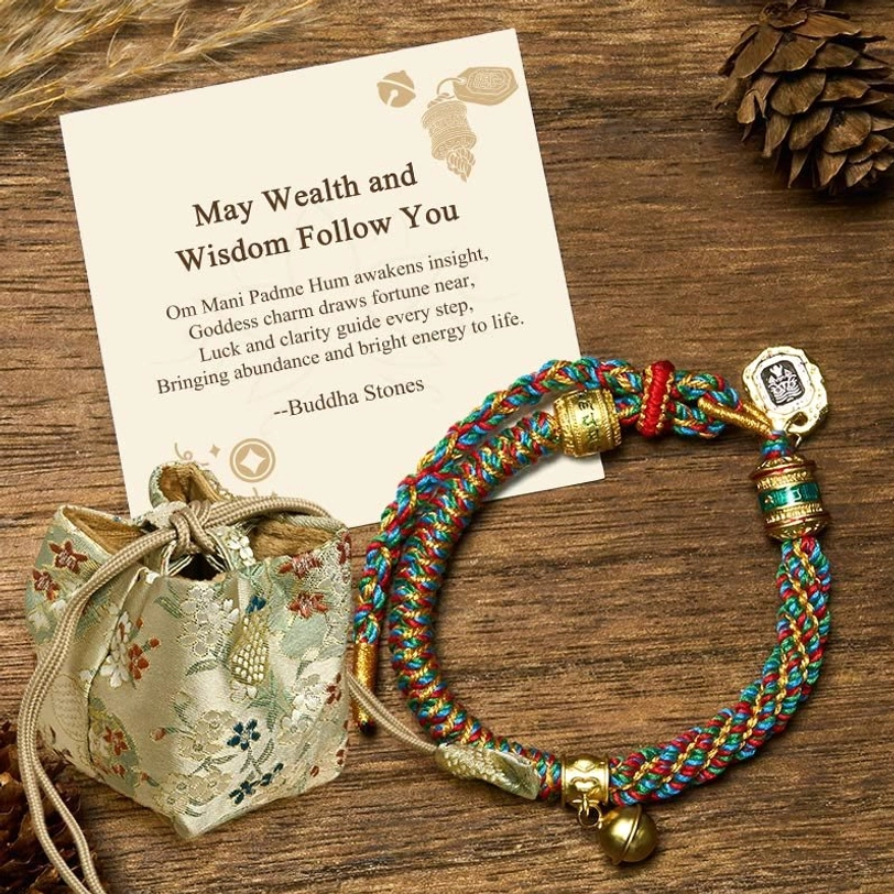 Zakiram goddess charm Tibetan Om Mani Padme Hum bracelet with deluxe brocade gift bag on wooden surface with decorative elements