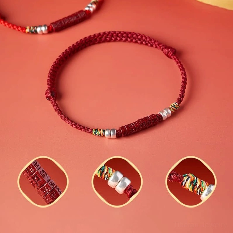 Red string sacred bracelet with detailed zoom views of cinnabar beads and silver accents