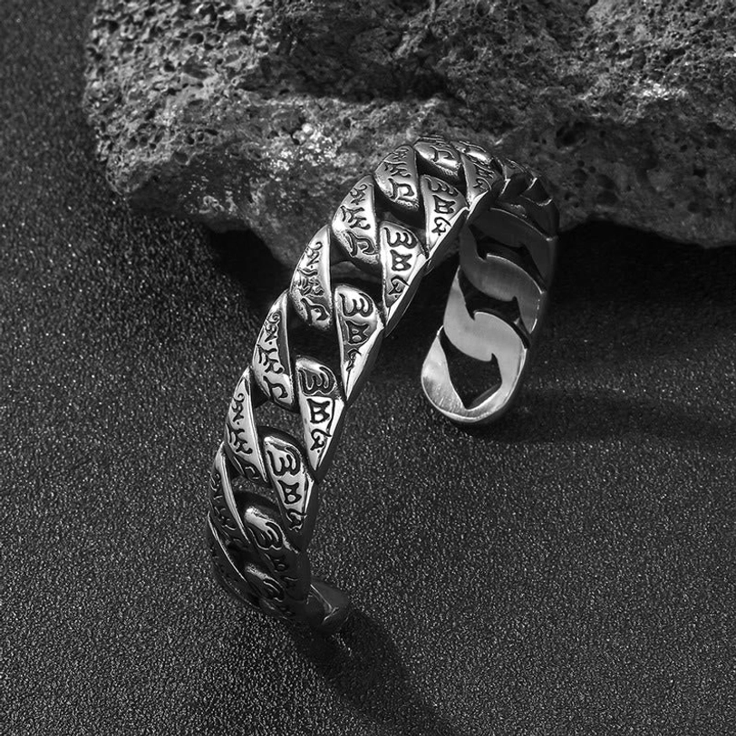 Antique silver titanium cuff bracelet with carved Tibetan script detail, close-up side view showing engraved mantra text