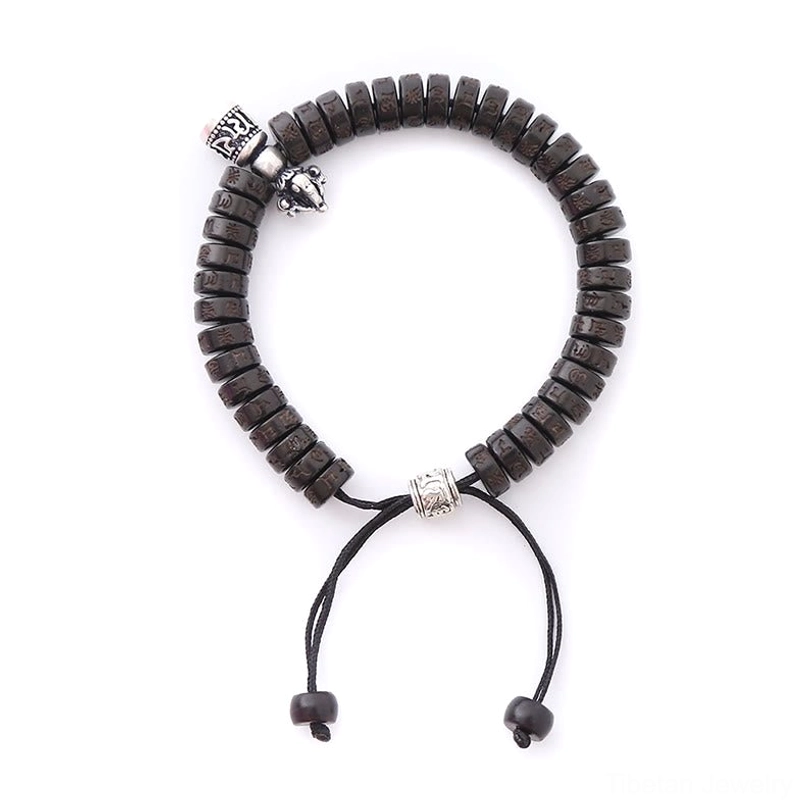 Handcrafted Tibetan coconut shell beaded bracelet, front flat view showing vintage silver vajra bell charm and black drawstring closure
