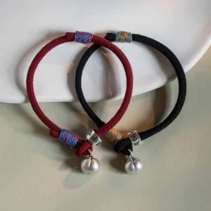 Red and black om mani padme hum persimmon charm bracelets with matching silver charms displayed together