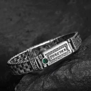 Close-up side perspective of the copper Om Mani Padme Hum bracelet showing detailed twisted woven chain and engraved mantra plaque with decorative accents