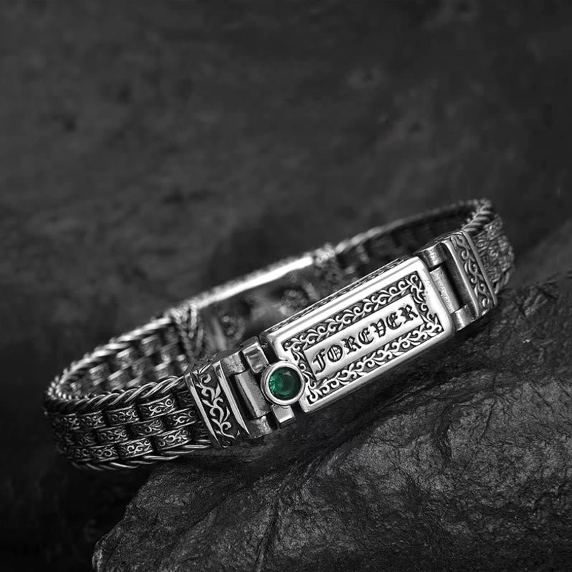Close-up side perspective of the copper Om Mani Padme Hum bracelet showing detailed twisted woven chain and engraved mantra plaque with decorative accents