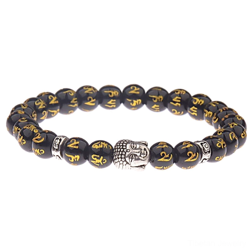 Handmade Tibetan Buddhist mantra bracelet featuring black beads with gold Om Mani Padme Hum characters and silver Buddha head charm