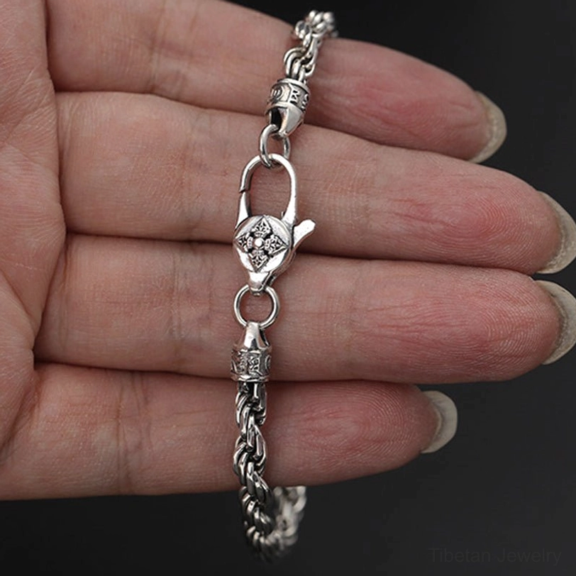 Om Mani Padme Hum Double Dorje sterling silver twisted rope bracelet worn on wrist showing fit and movement