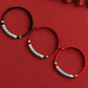 Set of three adjustable tibetan mantra bracelets in black and red rope with engraved silver tubes showing mantra variations
