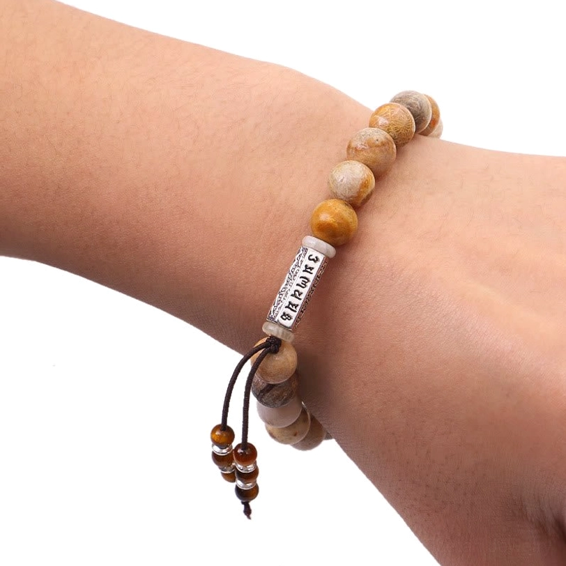 Weathered stone Om Mani Padme Hum bracelet worn on wrist, showing true-to-life fit and comfort on human model