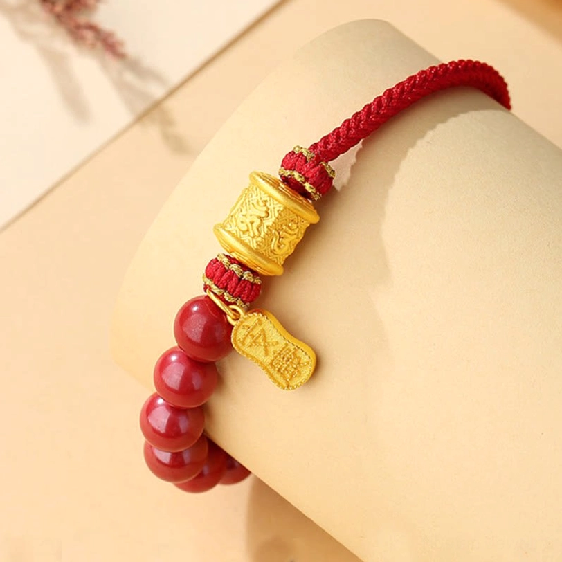 Sacred cinnabar blessing bracelet worn on female wrist close-up showing fitted woven cord and hanging silver charm