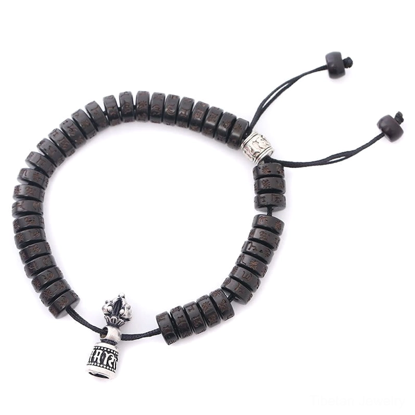 Tibetan coconut shell Om Mani Padme Hum bracelet, top view with engraved silver mantra pendant and dark brown natural beads