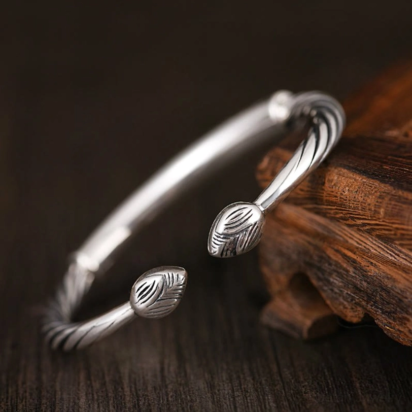 Dual feather-shaped open ends on aged copper twisted cuff bracelet