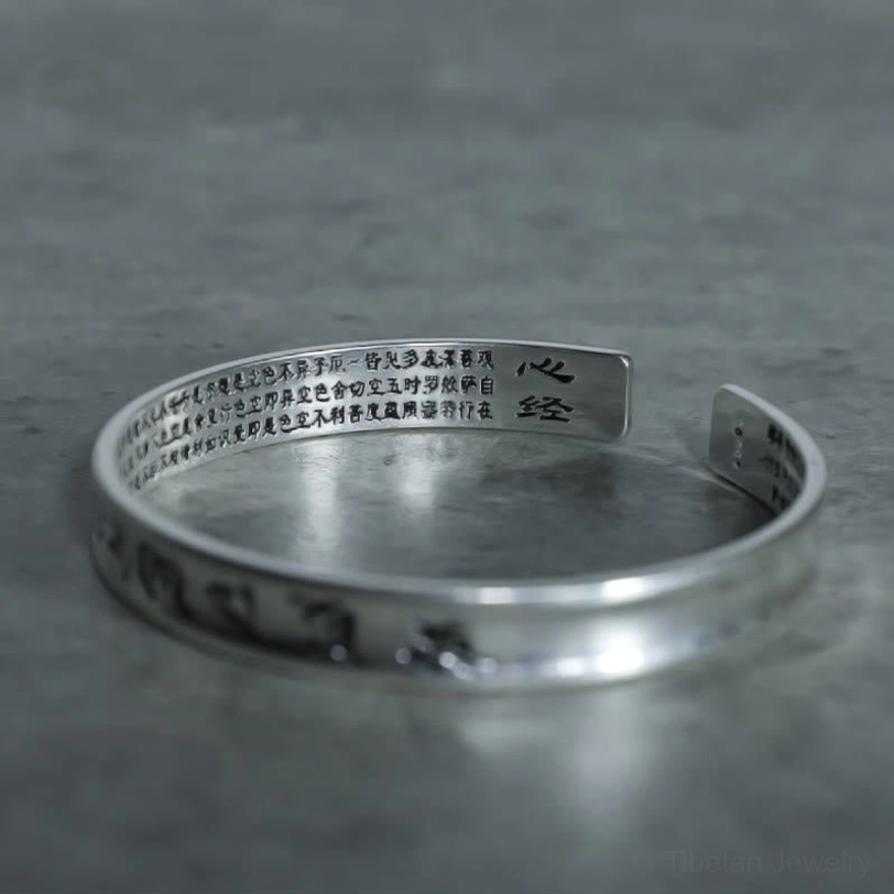 Tibetan Heart Sutra and Om Mani Padme Hum copper bracelet close-up showing inner band with Chinese text inscription
