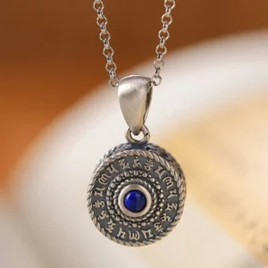 Close-up front view of handmade Sterling Silver Om Mani Padme Hum necklace pendant with deep blue lapis lazuli center stone and antique silver tone finish