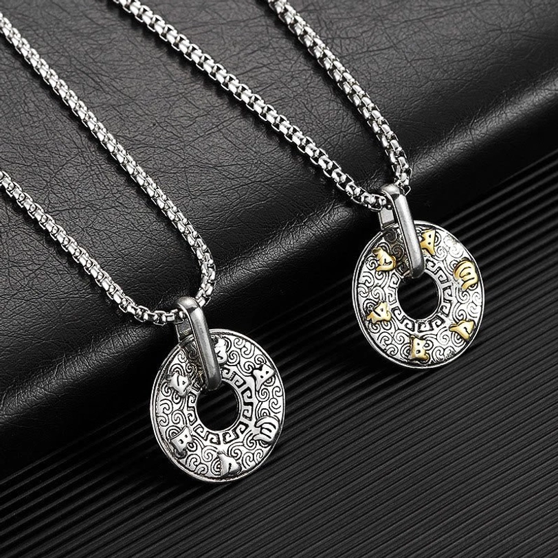 Pair of matching Om Mani Padme Hum tibetan necklaces displayed on black leather textured background showing different sizes