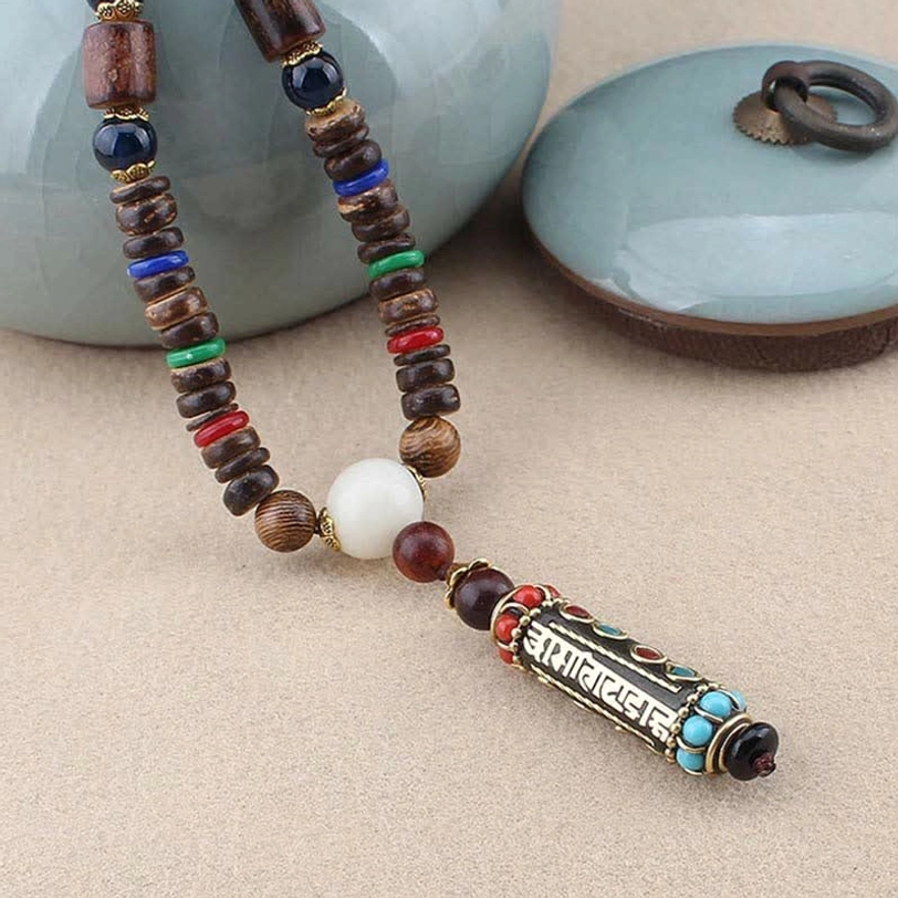Single Om Mani Padme Hum Tibetan bead necklace with wooden beads and white accent bead, side view