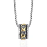 Om Mani Padme Hum titanium steel rotating necklace pendant with two-tone silver and gold finish, front overhead view on white background