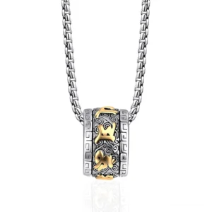Om Mani Padme Hum titanium steel rotating necklace pendant with two-tone silver and gold finish, front overhead view on white background