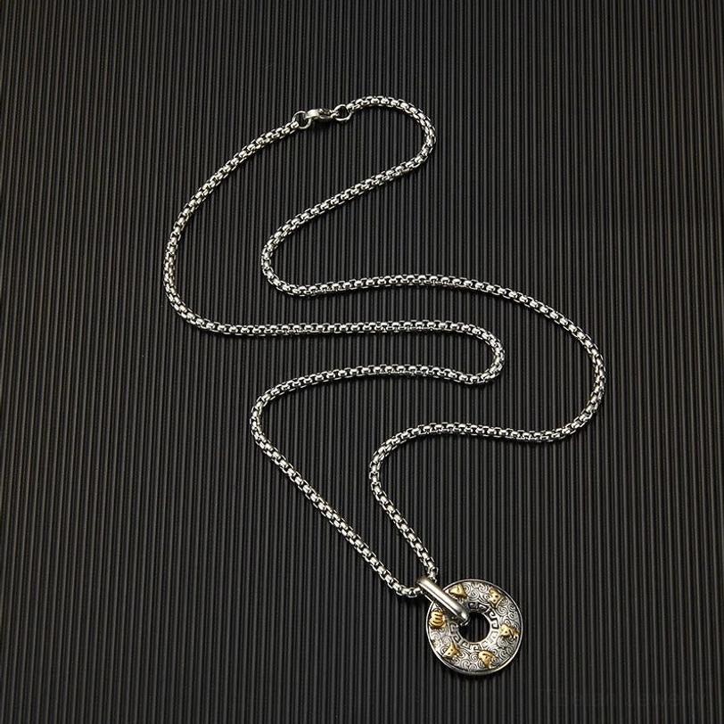 Loose Om Mani Padme Hum pendant and thin box chain set displayed on dark background ready for wearing