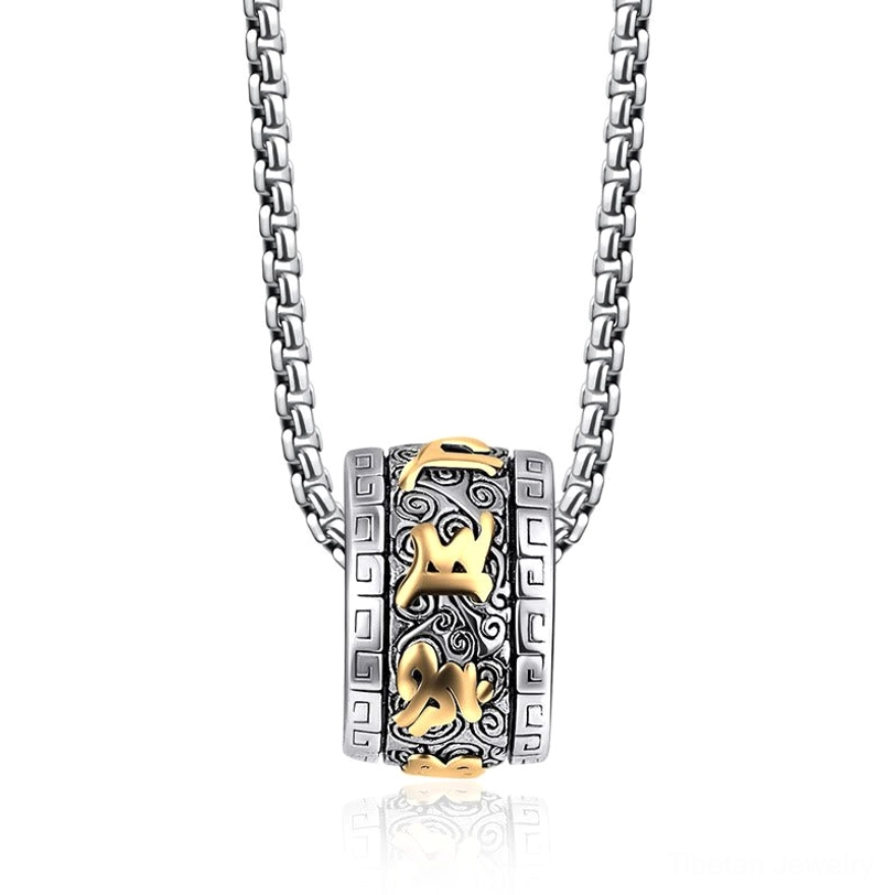 Close-up detail of Om Mani Padme Hum two-tone titanium steel barrel pendant with clearly carved Sanskrit mantras on white background