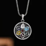 Om Mani Padme Hum silver pendant necklace with filigree hollow design and enamel colored mantra patterns on dark background