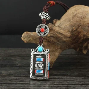 Tibetan six true words prayer wheel pendant front view, turquoise blue design, fixed prayer tube with silver alloy frame and adjustable dark brown rope