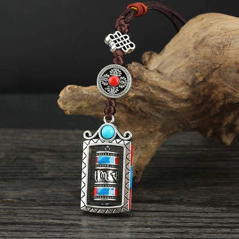 Tibetan six true words prayer wheel pendant front view, turquoise blue design, fixed prayer tube with silver alloy frame and adjustable dark brown rope