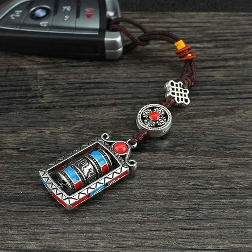 Six true words prayer wheel pendant worn as accessory, adjustable cord fit demonstration, Tibetan Buddhist spiritual keychain