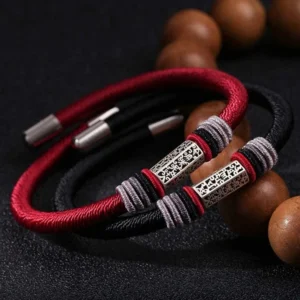 Red and black Om Mani Padme Hum blessed cord bracelets with silver charms and prayer beads displayed together