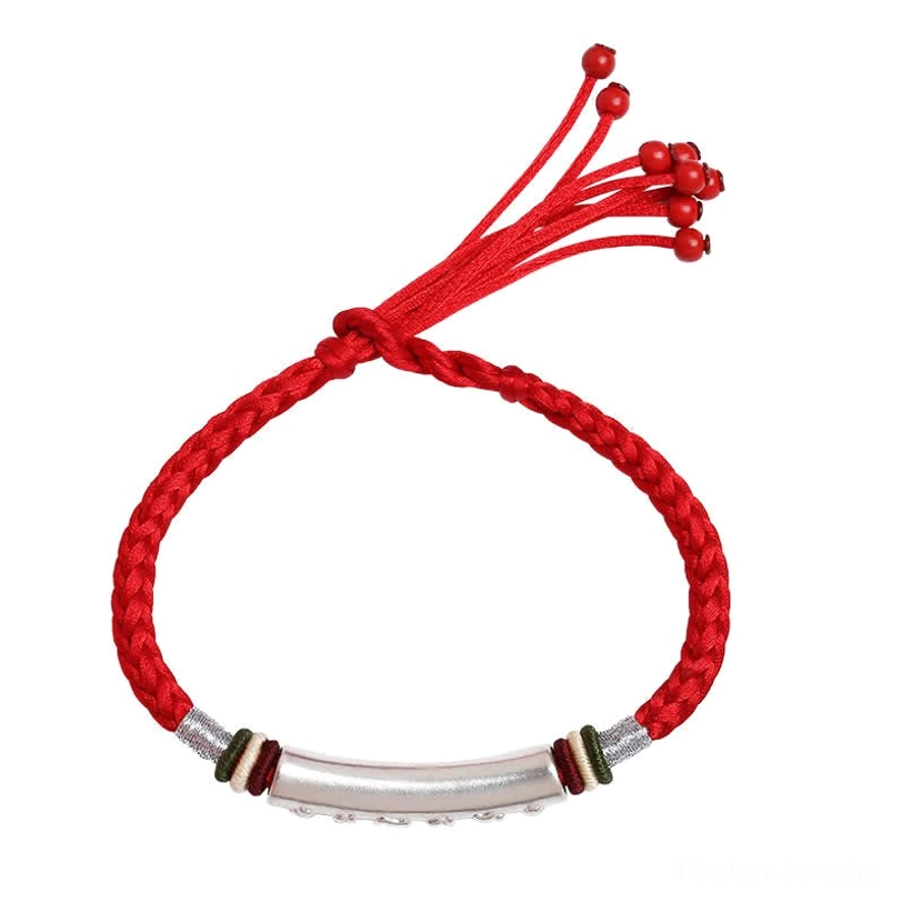 Front flat lay view of Tibetan protection bracelet with full clarity of silver tube and braided rope