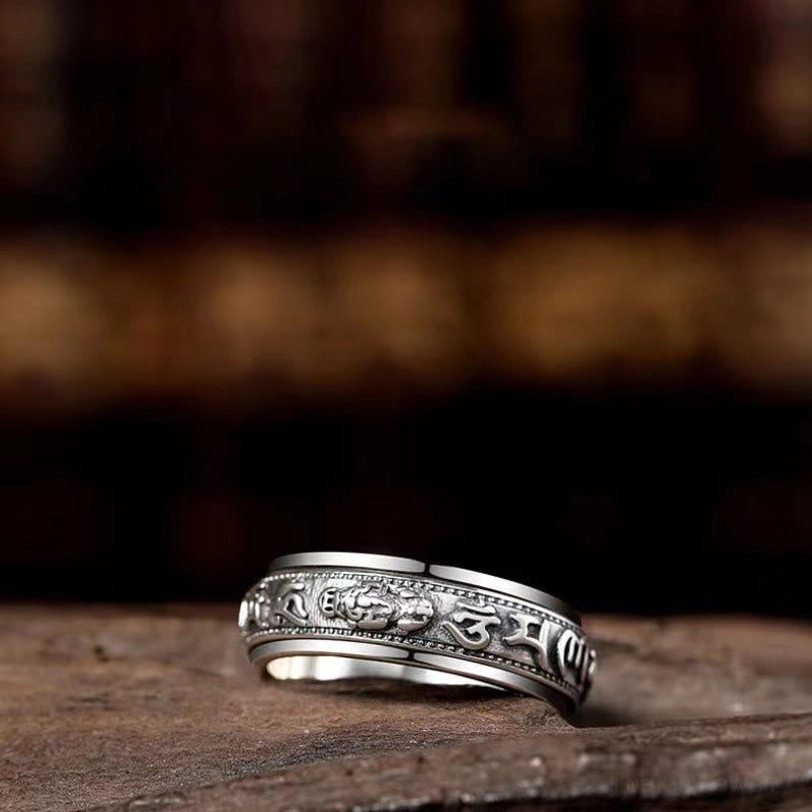 Close-up side view of handcrafted Pixiu ring showing detailed carved Buddhist mantras and vintage finish