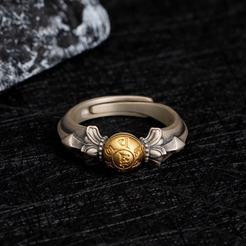 Adjustable Manjusri wisdom ring displaying flat frontal view with two-tone silver and gold mantra bead finish on dark textured background