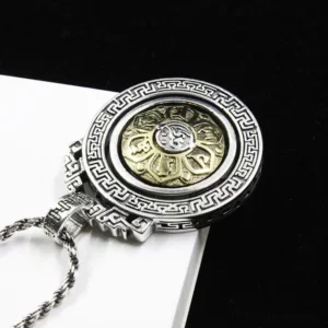 Rotatable Buddhist mantra pendant with dual-tone finish and engraved geometric border detail