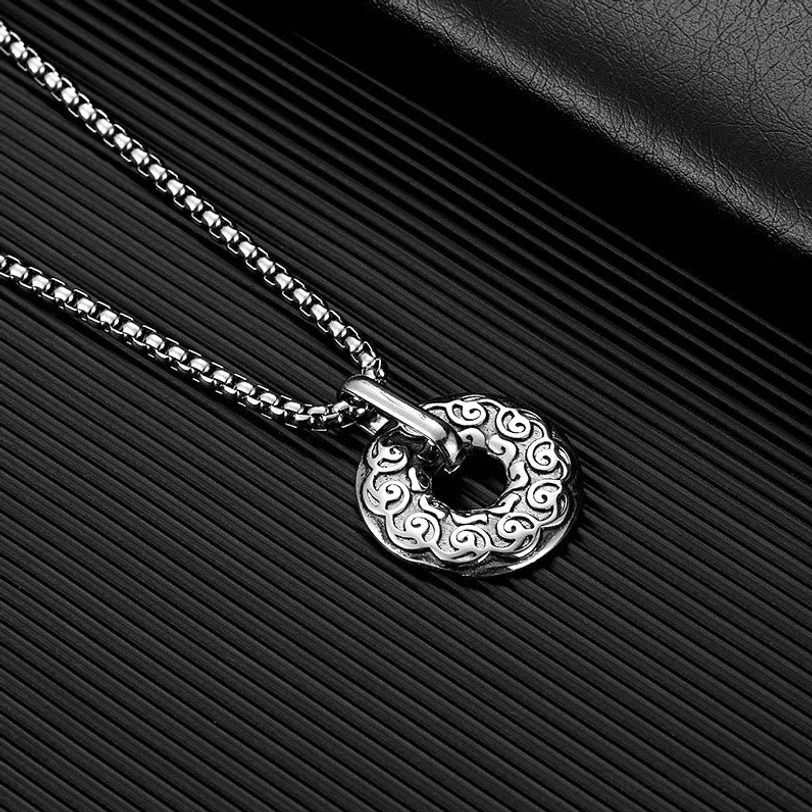 All-silver Om Mani Padme Hum donut pendant necklace with engraved cloud patterns and tibetan script on matte background