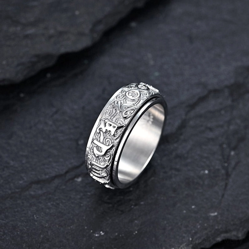 Two-piece spinner ring set featuring one silver and one gold tone ring with identical sacred mantra designs