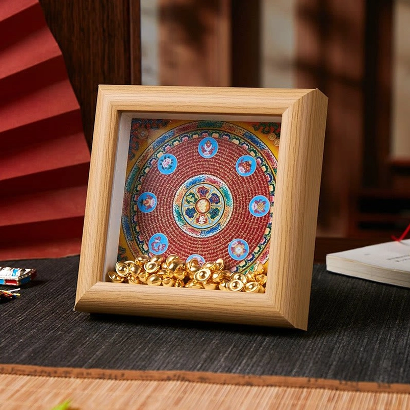 Om Mani Padme Hum thangka frame with colorful circular mandala and golden ingot embellishments on light wood frame, tabletop display