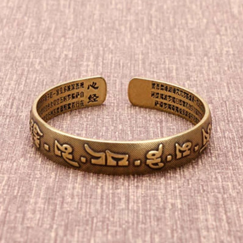 Tibetan Om Mani Padme Hum cuff bracelet stack showing multiple designs