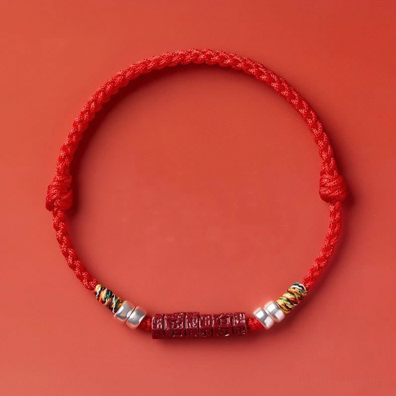Om Mani Padme Hum Tibetan blessing cord bracelet in vibrant red with carved ornaments