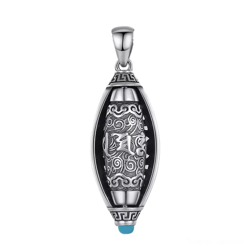 Front close-up of Tibetan Om Mani Padme Hum rotatable pendant showing carved inner tube detail and blue gem accent