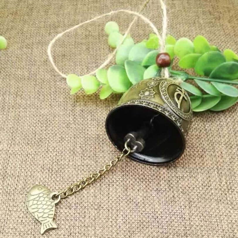 Open-top bronze wind chime bell showing interior design with visible fish charm and hemp rope hanging loop