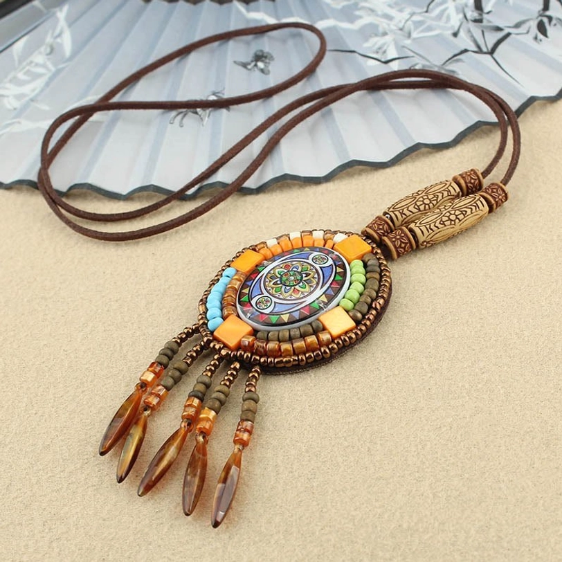Oval Tibetan mandala pendant necklace in blue and orange tones with beaded tassel and wooden clasp