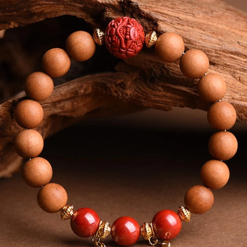 Peach wood cinnabar bracelet without tassels featuring tan wood beads and carved red focal bead in minimalist style