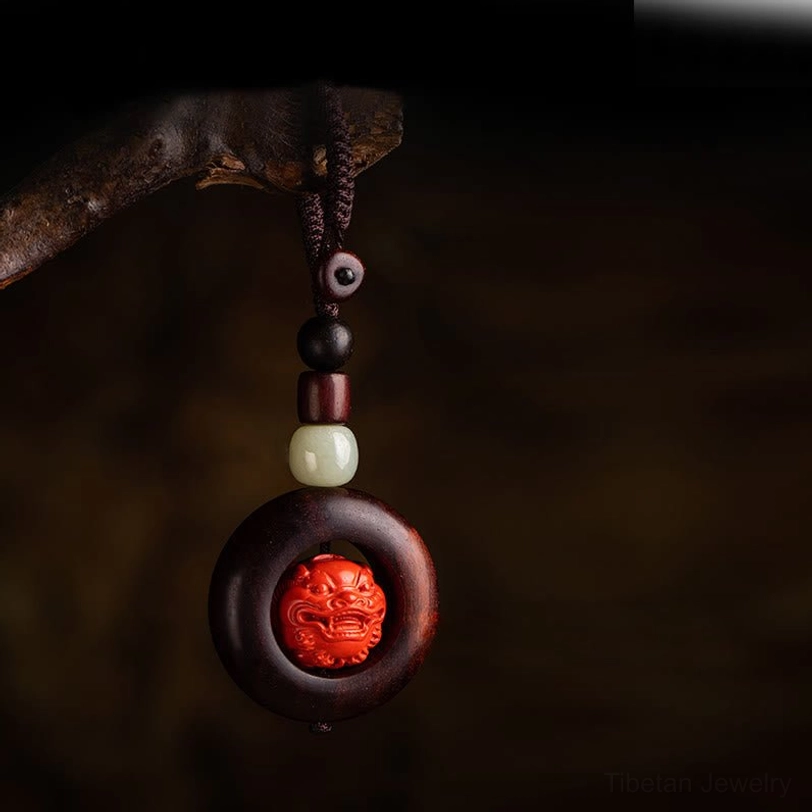 Pi Xiu wealth protection keychain detail showing intricate carving and cinnabar craftsmanship