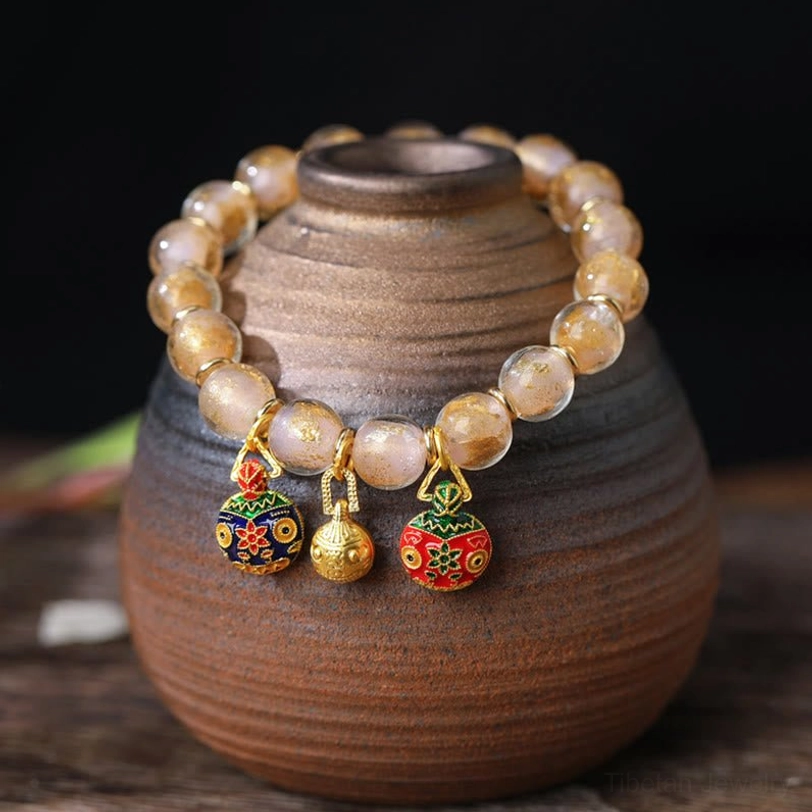 Light beige pink gold liuli glass bead bracelet with protective swallowing beast charm