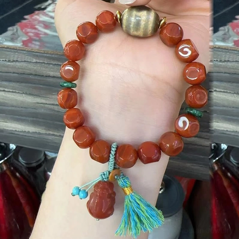 South Red Agate Pixiu Bracelet Worn on Wrist - First-Person Perspective Showing Faceted Red Agate Beads, Turquoise Tassel and Pixiu Charm in Use