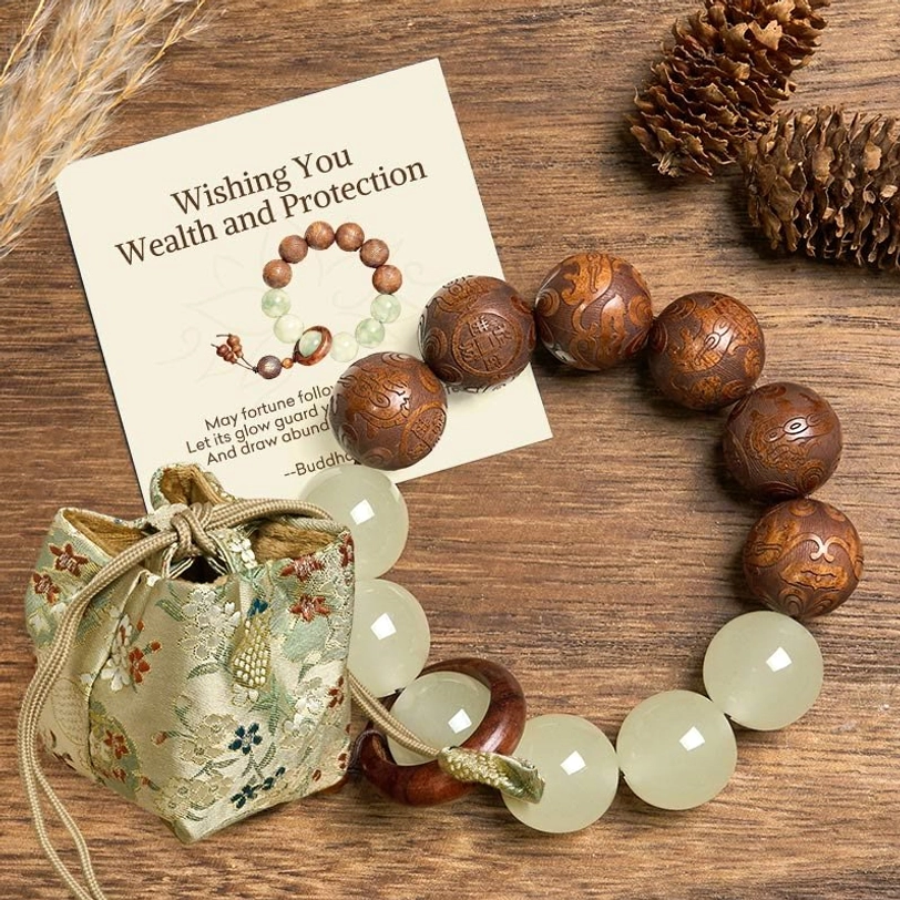 Pixiu fu bracelet with deluxe embroidered gift pouch and message card displayed on wooden table with pine cone decorations